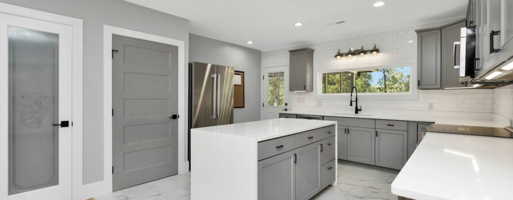 a kitchen with white cabinets